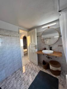 a bathroom with a sink and a mirror at Lux Mykonos house in Agios Stefanos