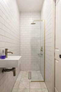 a white bathroom with a sink and a shower at Jane's View - Luxury apartment with breathtaking views in Kent