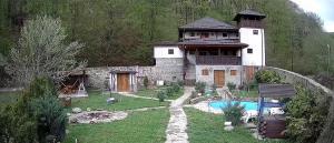 a large house with a pool in front of it at Casa cu Turn in Sărata-Monteoru