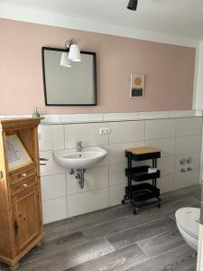 a bathroom with a sink and a mirror at Meerblick und Salz in der Luft in Fehmarn