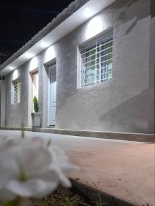 a white house with a white flower in front of it at Casa entre Montañas in San Juan