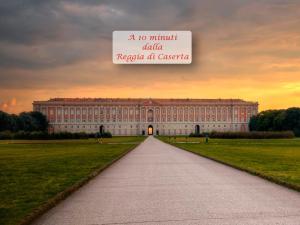 a large building with a sign that reads nomit publicrepublic at c at Caserta Deluxe in Caserta