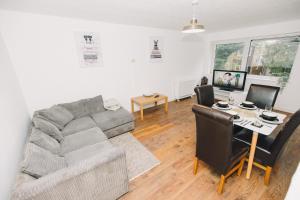 a living room with a couch and a table at Luxe Spacious & Central 2Bed Luton Apartment - Free Parking - Free Wi-Fi - Near LTN Airport & L&D Hospital in Luton