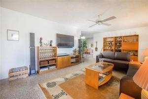 a living room with a couch and a table at Oasis on Siesta Key in Sarasota