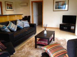 a living room with a couch and a coffee table at The Villa On Pine Tree in Grindelwald