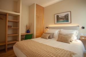 a bedroom with a large white bed with pillows at Vila Rodrigues in Lisbon