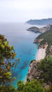 a view of the ocean from a cliff at Villa Maria 1 in Paleokastritsa +9 photos