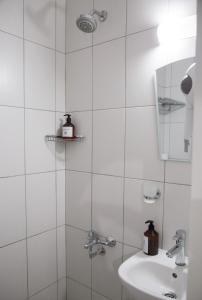 a white bathroom with a sink and a shower at Amsterdam Otel Economic Room in Kemer