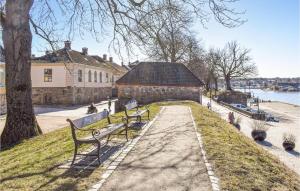 a row of park benches in front of a building at 3 Bedroom Beautiful Apartment In Gamle Fredrikstad in Vaterland