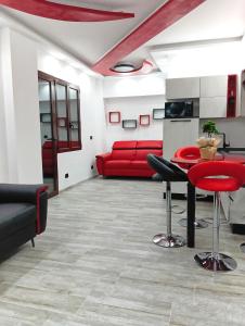 a living room with a red couch and a table at La casa di SELLY 2 - A Due Metri Dal Mare- in Bergeggi