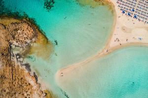 an overhead view of a beach with people in the water at Anmaria Beach Hotel & Spa in Ayia Napa