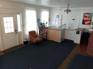 a kitchen with a counter and a chair in a room at Surf Villa Hotel in Ocean City