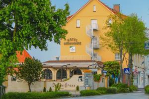 a yellow building with stairs on the side of it at Hotel Mira Mare in Heiligenhafen