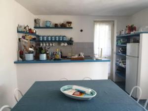 a kitchen with a table with a bowl of food on it at Dammuso Tuffo nel mare in Pantelleria
