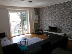 a living room with a couch and a tv at Appartement à Limoges in Limoges