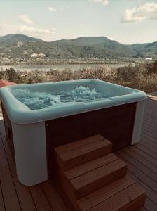 a bath tub sitting on top of a deck at Hillside Nagymaros in Nagymaros