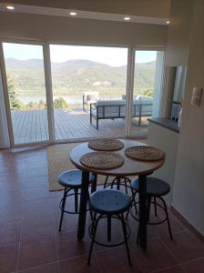 a table and chairs in a room with a view at Hillside Nagymaros in Nagymaros
