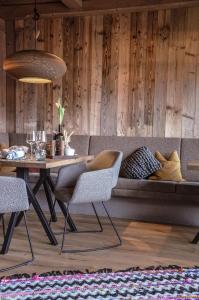 a dining room with a couch and a table at Hotel Ehrwalderhof in Ehrwald