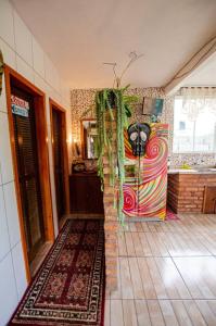 a room with a kitchen with a refrigerator in it at Hostel Quintal do Rosa in Praia do Rosa