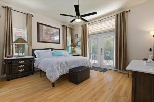 a bedroom with a bed and a ceiling fan at KMEL HOME in Bakersfield