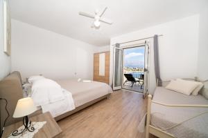a bedroom with a bed and a ceiling fan at Apartments Siesta in Sumartin