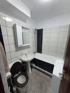 uma casa de banho com um WC, um lavatório e uma banheira em GARSONIERA ÎN REGIM HOTELIER em Târgu Jiu