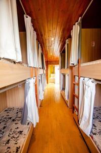 a hallway in a train car with bunk beds at Hostel Quintal do Rosa in Praia do Rosa