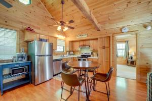 a kitchen with a table and chairs and a refrigerator at Bryson City Vacation Rental - Hot Tub and Lake Views in Lauada