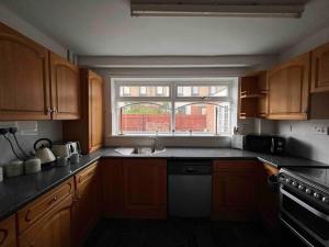 a kitchen with a sink and a window in it at Homely 4 bed quiet neighbourhood w/ huge driveway in Lemington