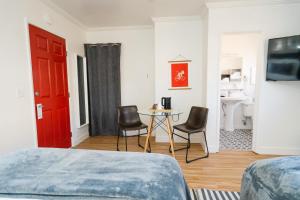 1 dormitorio con puerta roja, mesa y sillas en Viking Inn, en Solvang