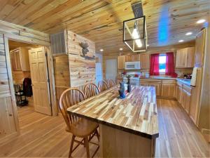 a kitchen with a table and chairs in a cabin at The Red Pine in Saint Ignace