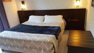 a bed in a hotel room with two pillows at Le Marina in Porto Ota