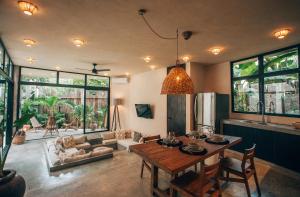 a living room with a table and a couch at Round Villa Private Pool & Jungle rooftop 2A in Tulum