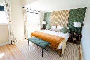 a bedroom with a bed and a chair and a window at Viking Inn in Solvang