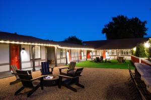 a patio with chairs and a table and lights at Viking Inn in Solvang