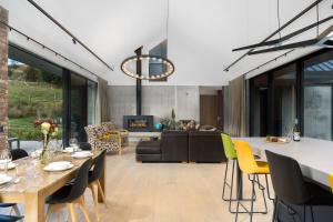 a living room with a table and chairs and a couch at Countryside Escape Arrowtown in Arrowtown