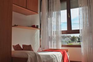 a bedroom with a bed and a large window at A Estribor - 20001 in Argoños