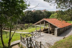 a small stone building with a roof on a hill at A Estribor - 20001 in Argoños