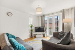 a living room with a couch and a tv at Luxnightzz - Two Bed - Close to North Station and Hospital in Colchester