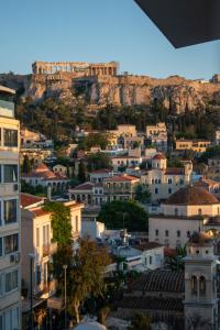 a view of a city with a mountain in the background at AcroView Right In The Center in Athens