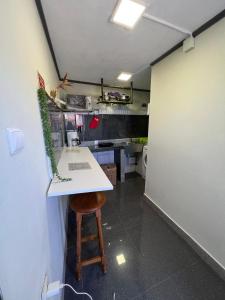 a kitchen with a counter and a stool in a room at Los Amantes de la naturaleza. in Salão