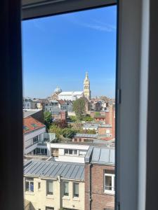 a view of a city from a window at Le Jean Bart - Lille Votre T1 meublé cosy & lumineux Quartier République in Lille