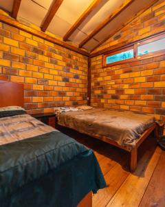 a room with two beds and a brick wall at Finca Valentina in Valladolid +65 photos