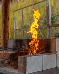 a fire is burning in a grill at Finca Valentina in Valladolid
