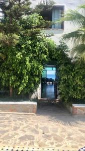 a doorway to a building with a hallway leading to the ocean at Magnifique Villa Front de Mer à Fnideq in Fnidek