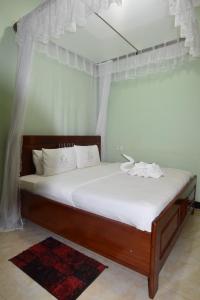 Ένα ή περισσότερα κρεβάτια σε δωμάτιο στο BETTER LIFE HOTEL KASULU