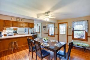 a kitchen and dining room with a table and chairs at Stamford Farmhouse with Deck in Catskill Foothills in Stamford