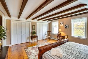 a bedroom with a bed and a table and chairs at Stamford Farmhouse with Deck in Catskill Foothills in Stamford