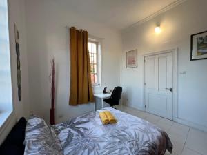 a bedroom with a bed with a yellow object on it at CoLiving Villa Brasil in Las Palmas de Gran Canaria