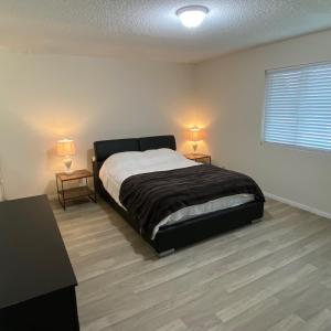 a bedroom with a bed and two night stands at House in Thousand Oaks in Thousand Oaks